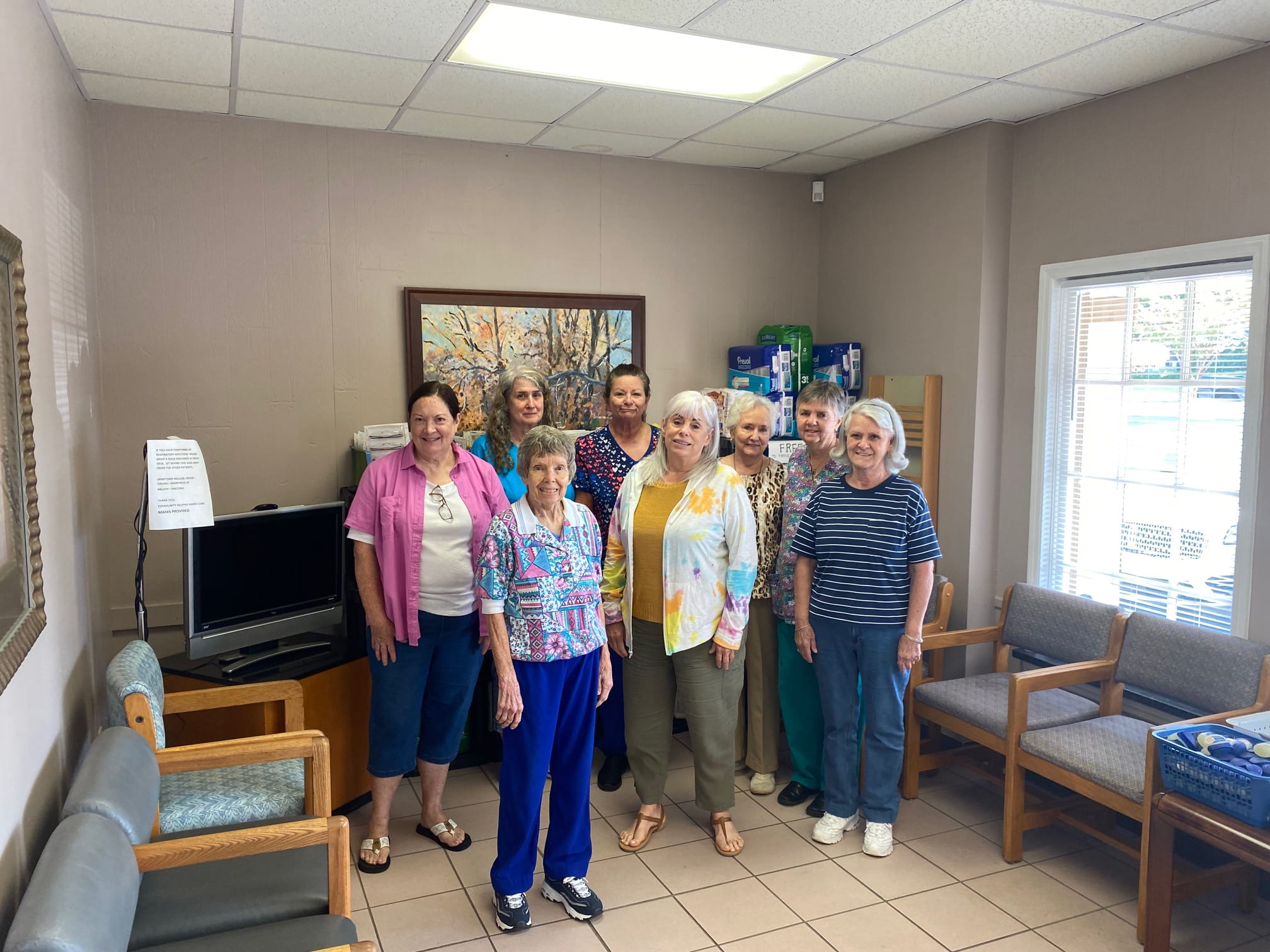 Volunteer medical staff providing free healthcare for uninsured families at Community Helping Hands Clinic in rural Georgia